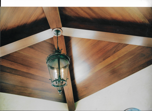 Wooden ceiling with slanted beams and a decorative hanging lantern.